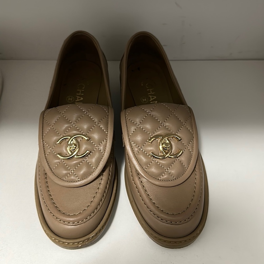 authentic Chanel turn lock leather loafers in tan. Amazing condition